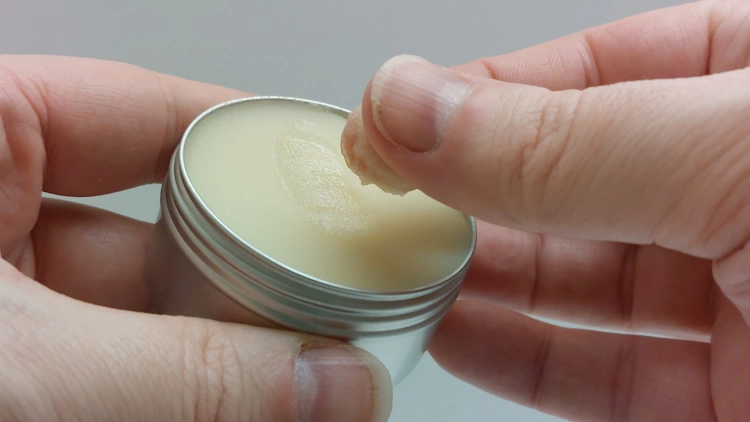 testing the texture of Honest Amish Beard Balm by rubbing it between fingers