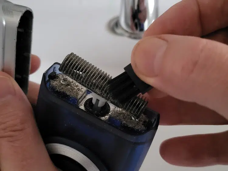 cleaning the Braun MobileShave M-60 with its brush