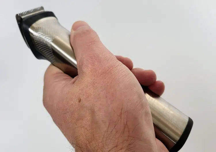 holding the Philips Norelco Multigroom MG7750 to show its ergonomics