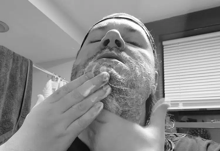 author Robert using beard wash in the bathroom
