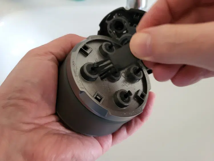 cleaning the Microtouch Titanium Head Shaver with a brush