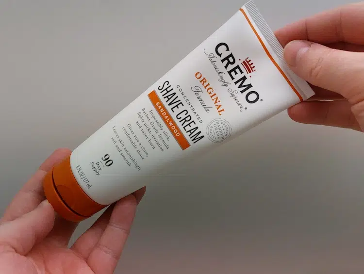 Cremo Shaving Cream Tube Held in hands