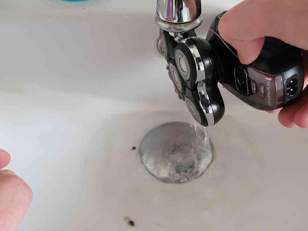 cleaning the Remington Balder Pro under a running tap