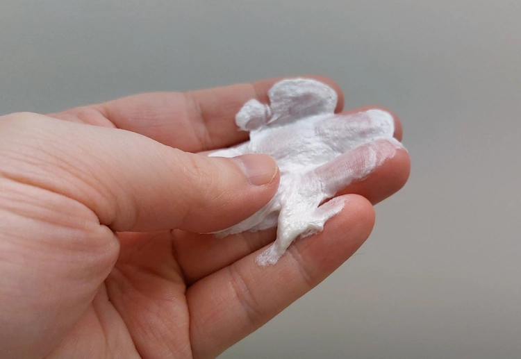 rubbing Cremo Shaving Cream between fingers to show and feel its texture