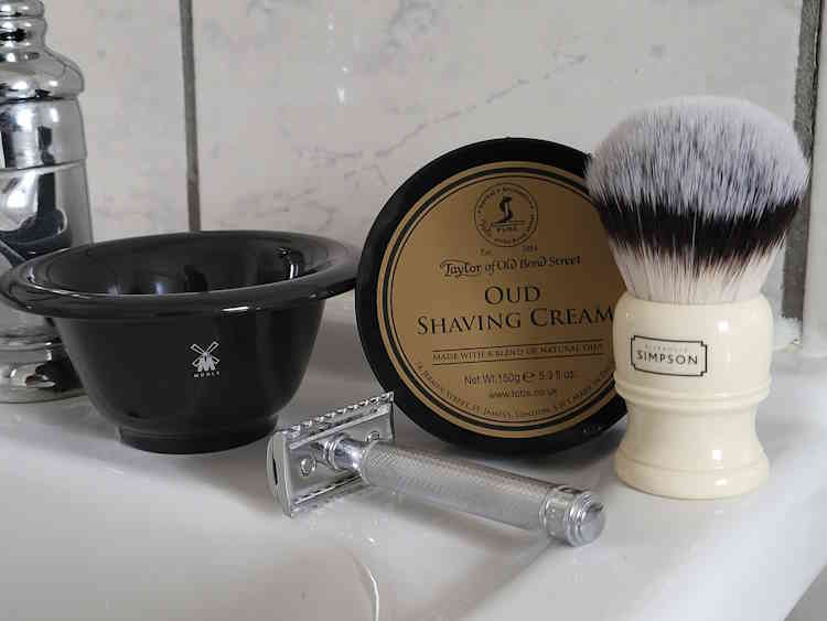 MÜHLE Porcelain Shaving Bowl next to shaving cream and brush and safety razor in bathroom