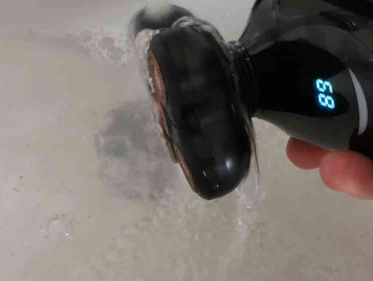 cleaning Brio Raze Head Shaver under running tap water