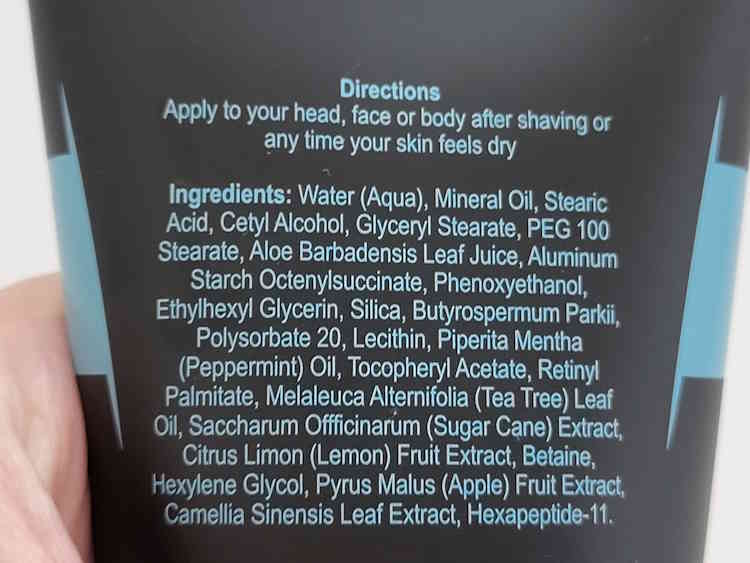 close up of Headblade HeadLube matte lotion ingredients on the back of the tube