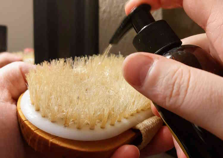 squirting Medicine Man Beard Wash on a beard brush reday to use