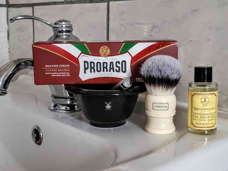 Proraso Red Tube on sink with safety razor, shaving bowl, brush and pre-shave oil