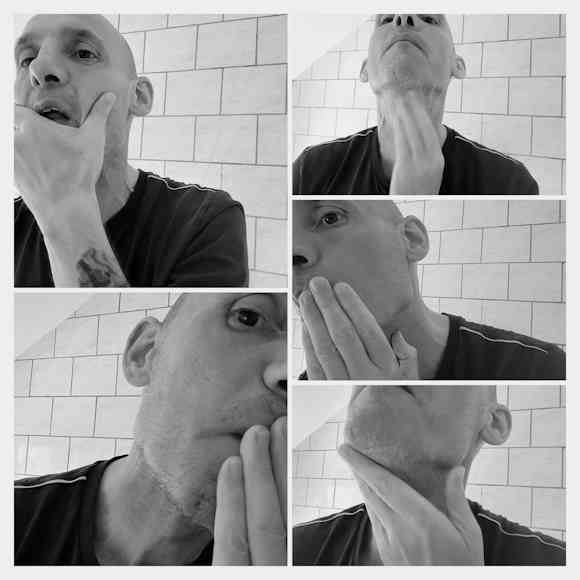 Reviewer Jason applying Taconic Pre Shave Oil Unscented to his face