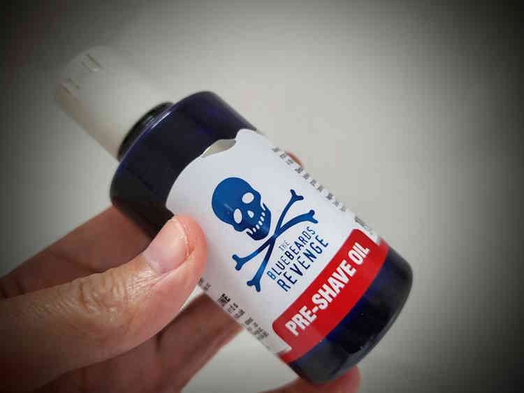 bottle of Bluebeards Revenge Pre-Shave Oil held in the hand