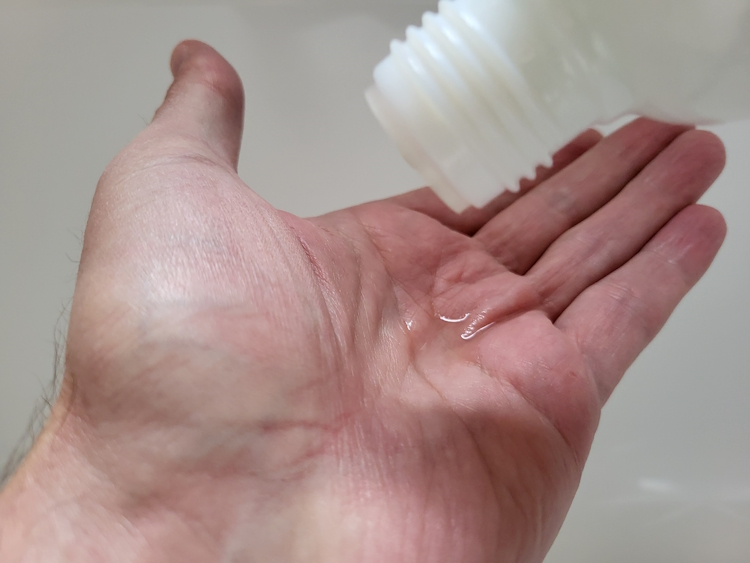 pouring Tabac Pre-Electric Shave Lotion on the hand ready to apply