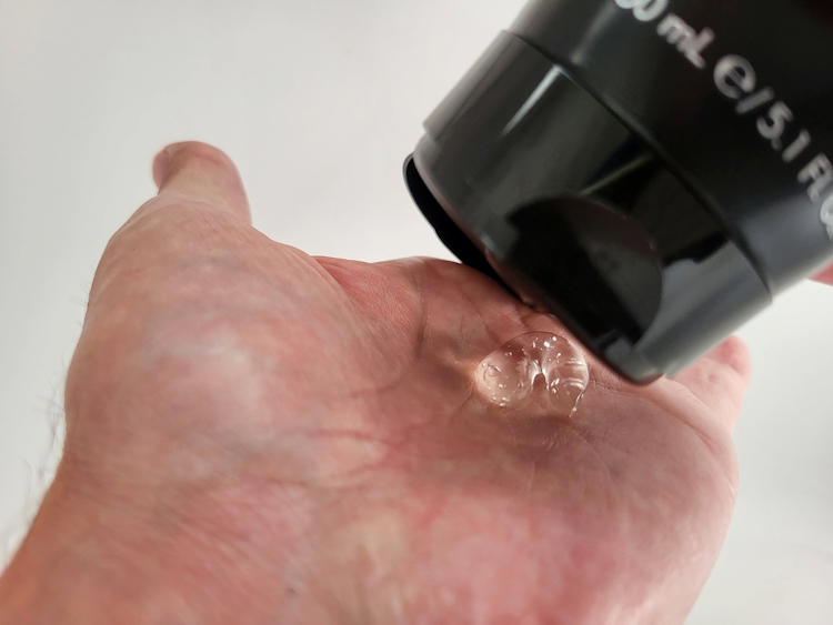 squeezing a small amount of American Crew Shave Gel from the tube