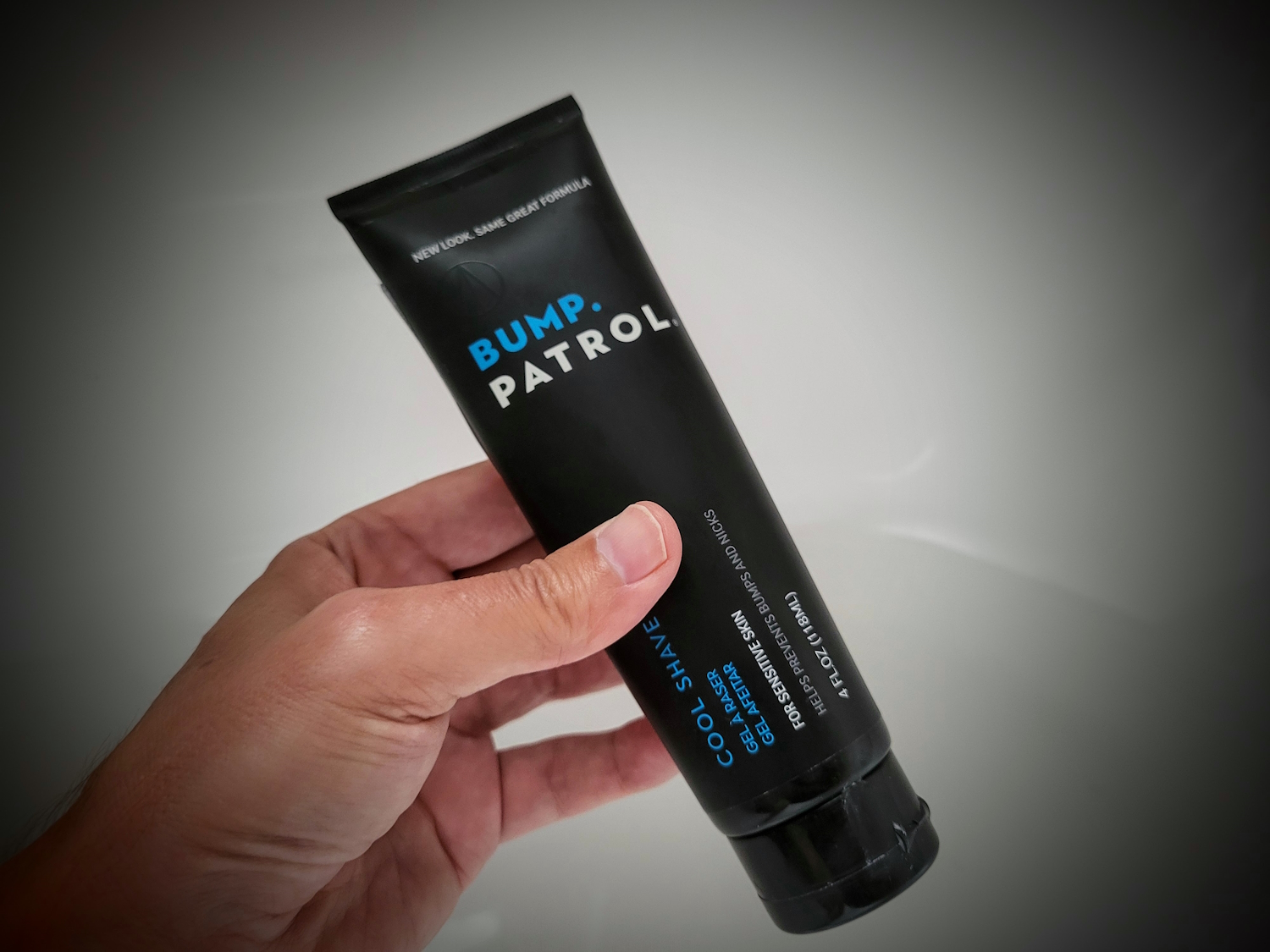 holding a tube of Bump Patrol shave gel