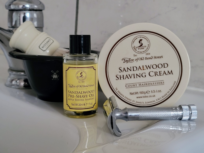 Taylor Of Old Bond Street Sandalwood Shaving Cream displayed on a sink with pre shave, razor and a shaving bowl