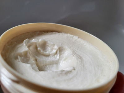 close up of Taylor Of Old Bond Street Sandalwood Shaving Cream top cap removed showing the cream texture