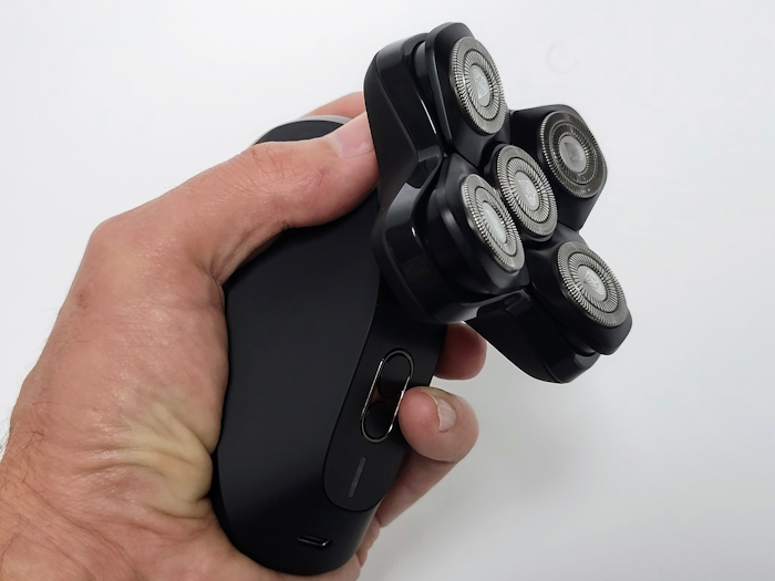 holding the Manscaped The Dome Shaver Pro to display its ergonomics