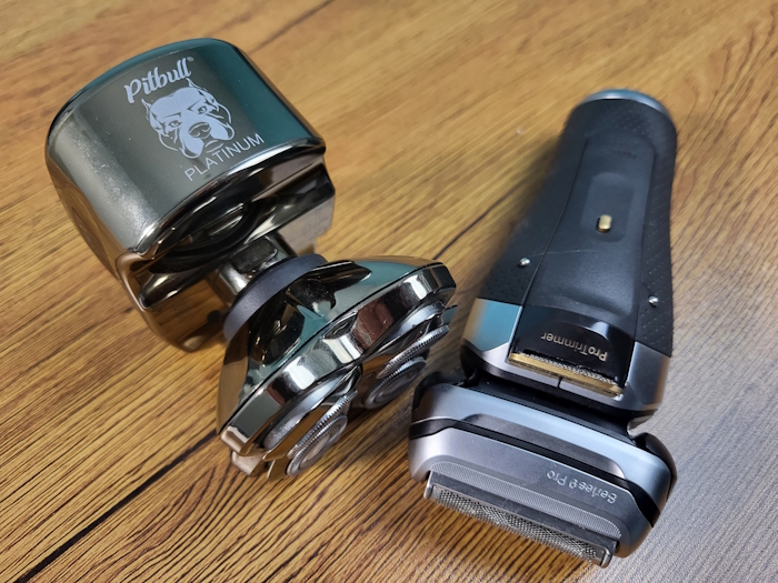 birds eye view of the Skull Shaver Pitbull next to a Braun Series 9 Pro on a wooden table