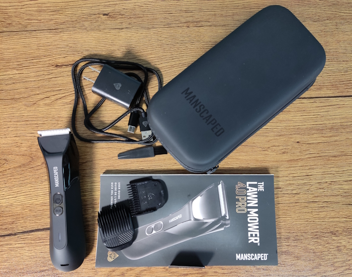 Manscaped Lawn Mower 4.0 Pro unboxed with all components laid out on a table