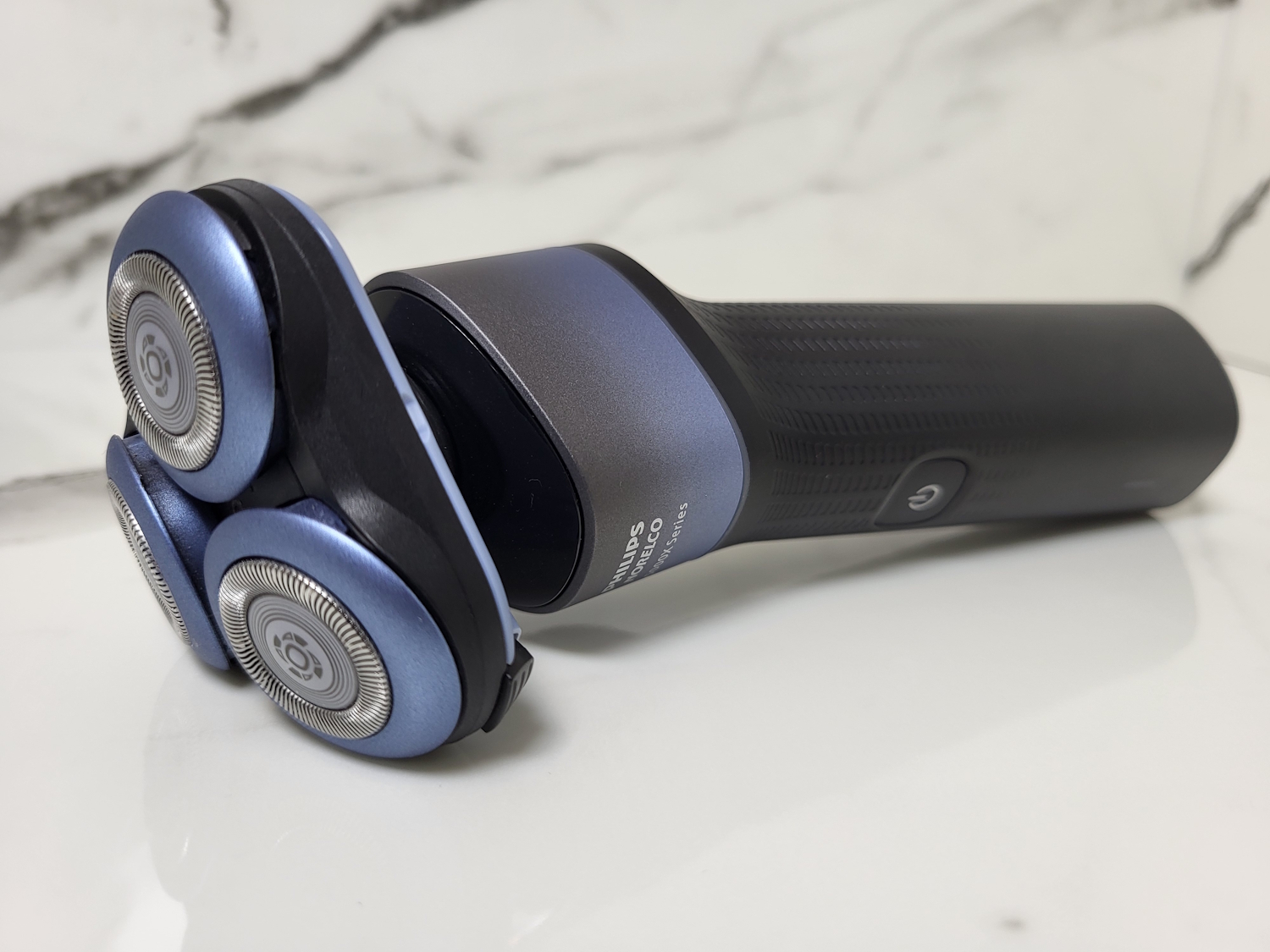 Philips 5000X Shaver laid down with marble background