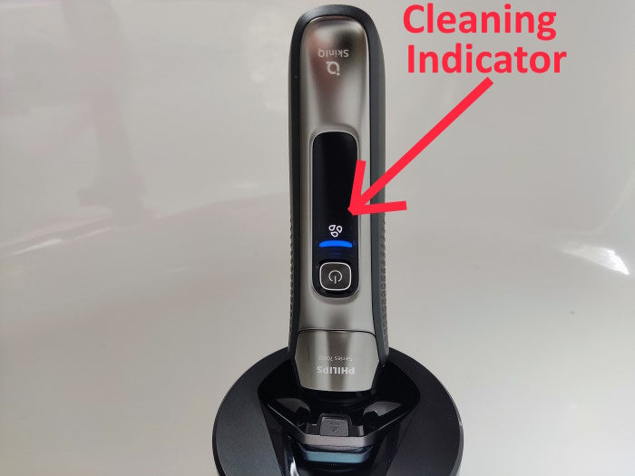 Philips S7000 in cleaning pod and displaying the cleaning indicator with text overlay
