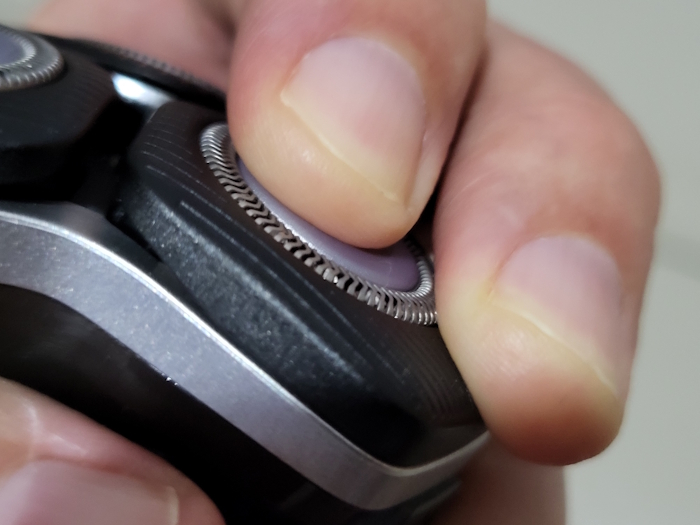 close up of pressing in Philips 5000 Series Shaver cutter blade to display that it flexes