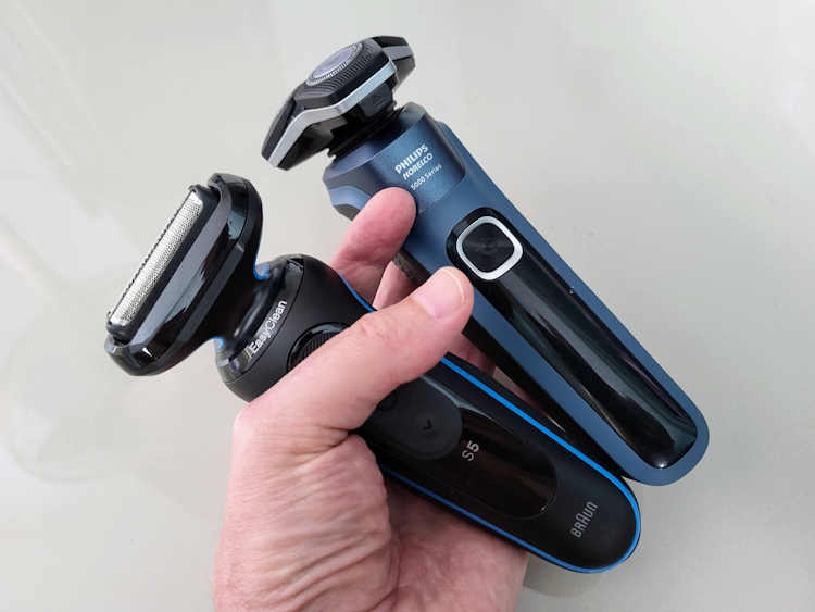 holding Braun Series 5 and Philips Series 5000 shaver in the same hand