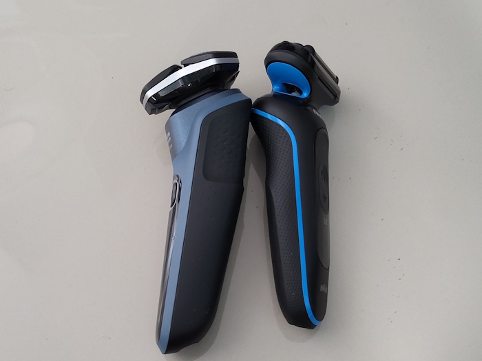 the Braun Series 5 and Philips Series 5000 shaver laid down side by side to display the size differences