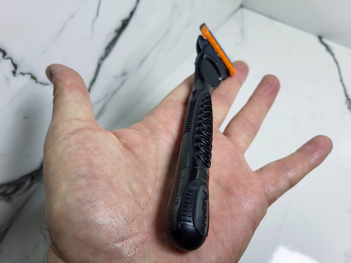 Gillette Fusion 5 Power Razor lying down on the hand to display that it is light