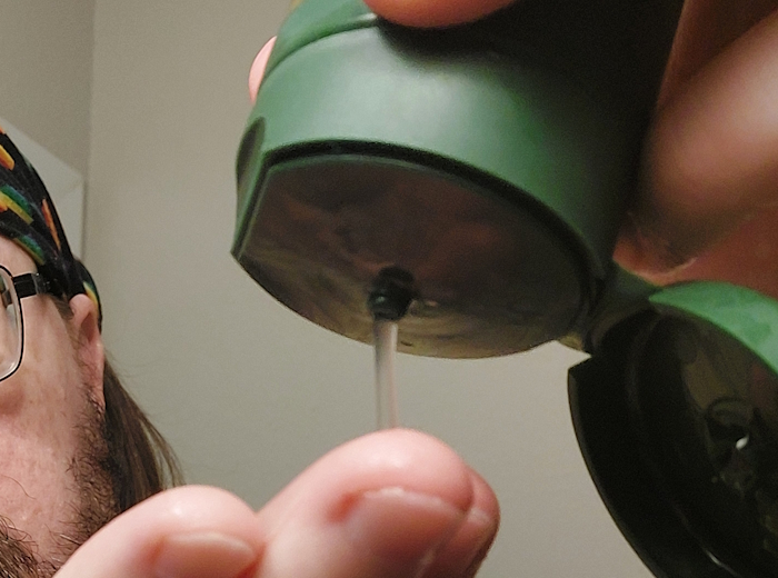 squeezing SheaMoisture Beard wash from the tube onto the hand
