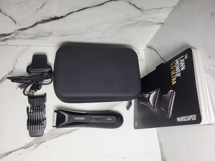Manscaped Lawn Mower 5.0 Ultra unboxed with all components laid out