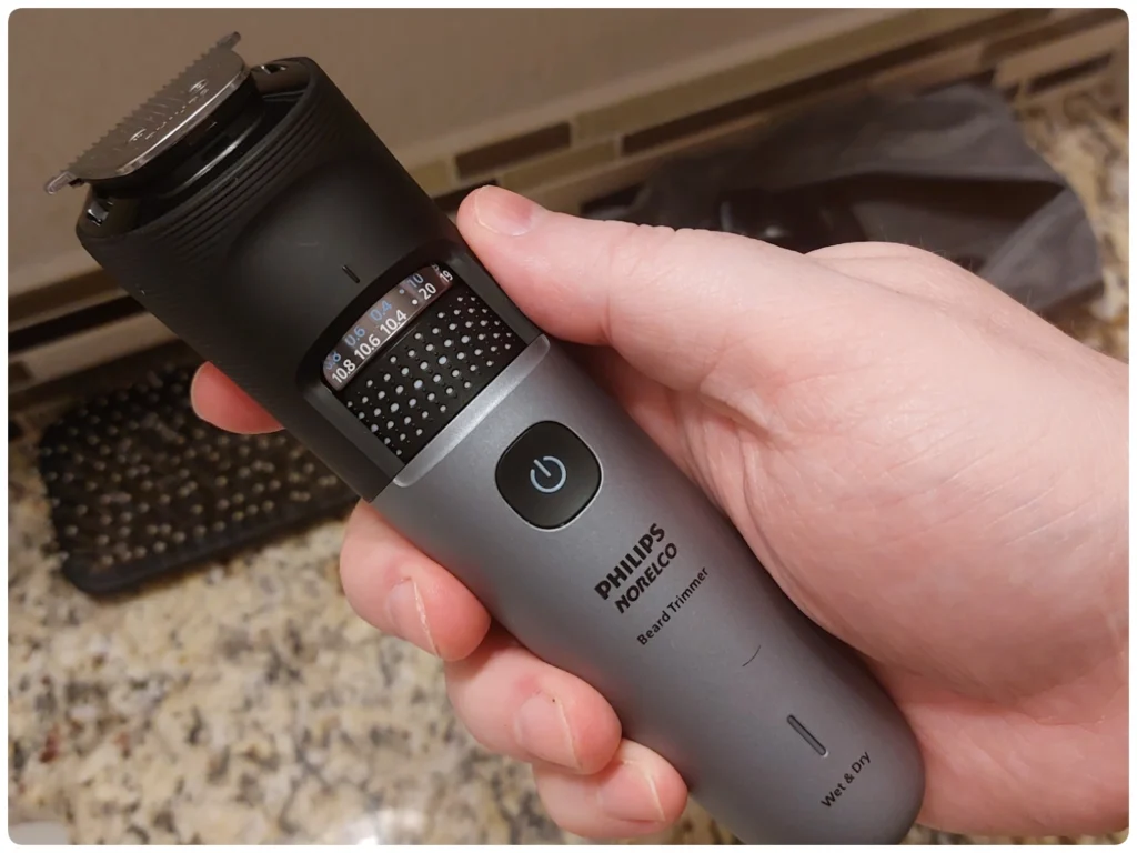 holding Philips Norelco Series 7000 Beard Trimmer to display its appearance