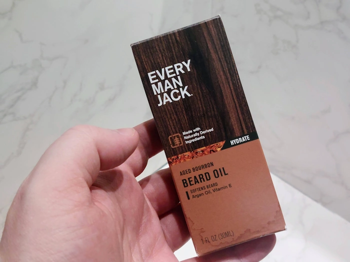 holding Every Man Jack Aged Bourbon Beard Oil in its box holding Every Man Jack Aged Bourbon Beard Oil in its box
