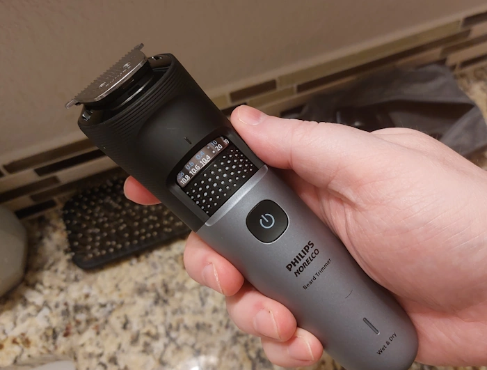 holding Philips Norelco Series 7000 Beard Trimmer to display the settings wheel