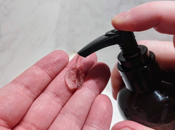 close up of squirting some Every Man Jack Beard Wash on the hand ready to use