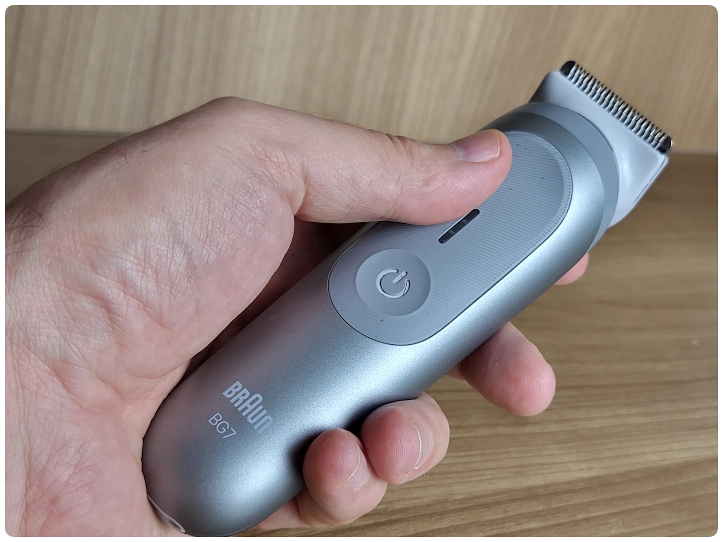 holding the Braun Body Groomer Series 7 to display its appearance