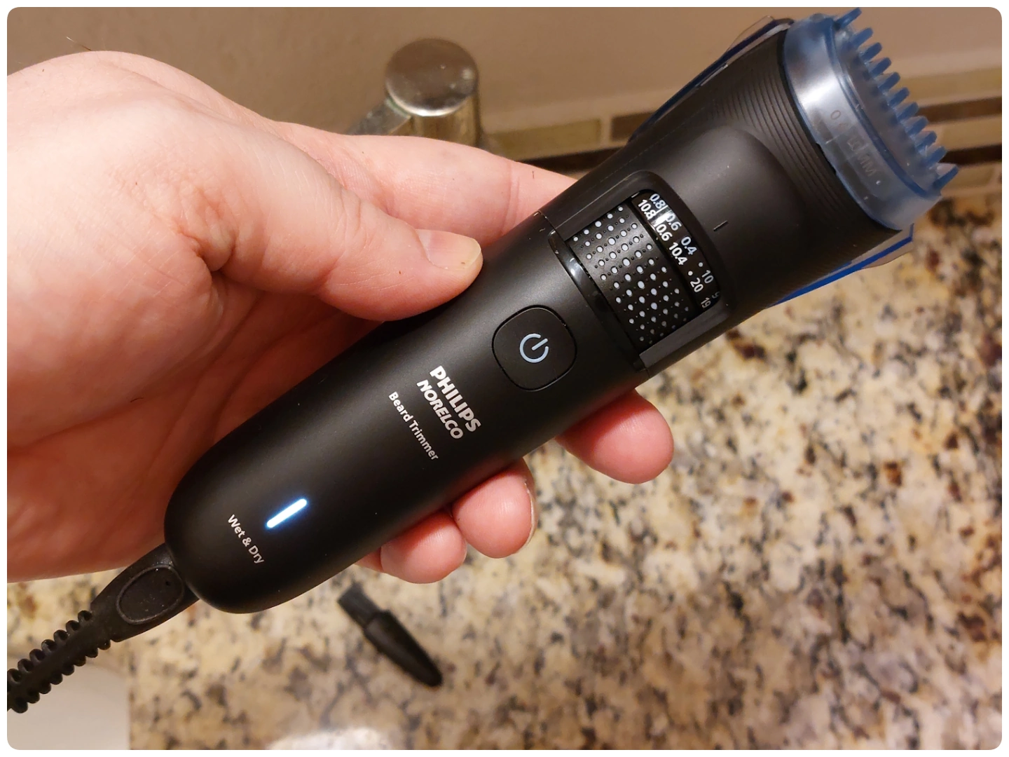 holding a Philips Norelco Beard Trimmer 5000 Series BT5775