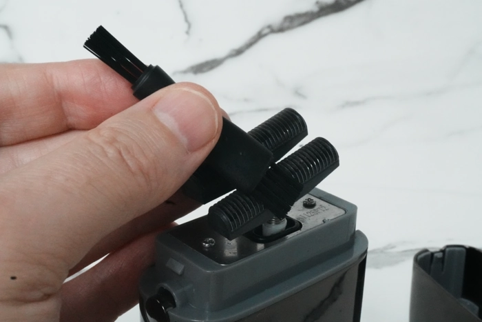 brushing the cutters on the Babyliss Pro shaver for cleaning purposes 