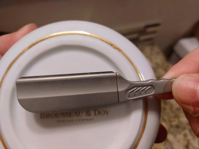 Feather SS Club Shavette blade section shown with a shaving bowl behind it